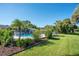 Spacious backyard with a swimming pool, mature trees, and well-maintained green lawn at 1155 E Fowler Dr, Deltona, FL 32725