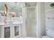 Bathroom featuring modern vanity with ample storage and a walk-in shower at 1155 E Fowler Dr, Deltona, FL 32725