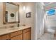 Bathroom with stylish vanity, framed mirror and glass enclosed shower at 1155 E Fowler Dr, Deltona, FL 32725