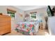 Cozy bedroom featuring a bright floral comforter and ample natural light at 1155 E Fowler Dr, Deltona, FL 32725