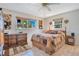 Bedroom with comfortable bed and view of landscaped yard at 1155 E Fowler Dr, Deltona, FL 32725
