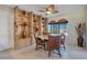 Well-lit dining room with a unique round table and custom brick shelving at 1155 E Fowler Dr, Deltona, FL 32725