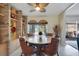Bright dining area with round table, brick shelving, and view to the outdoors at 1155 E Fowler Dr, Deltona, FL 32725