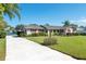 Well-maintained single-story house with a long driveway and view of the water at 1155 E Fowler Dr, Deltona, FL 32725