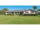 Charming single-story home with well-maintained lawn, red shutters, and mature landscaping at 1155 E Fowler Dr, Deltona, FL 32725