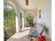 Inviting front porch area with brick floor, iron gates, and a bench for relaxing at 1155 E Fowler Dr, Deltona, FL 32725