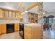 Kitchen area with light wood cabinets, breakfast bar, and view into dining area at 1155 E Fowler Dr, Deltona, FL 32725