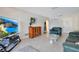 Cozy living room with tile floors, comfortable seating, and a modern entertainment center at 1155 E Fowler Dr, Deltona, FL 32725