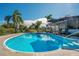 Large backyard pool with a clear blue surface, complemented by tropical foliage and ample space at 1155 E Fowler Dr, Deltona, FL 32725