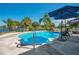 Refreshing pool surrounded by lush landscaping, offering a tranquil retreat with clear blue water at 1155 E Fowler Dr, Deltona, FL 32725