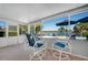 Bright sunroom with a table and chairs, plus tranquil views of the pool and lake at 1155 E Fowler Dr, Deltona, FL 32725