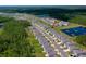 Aerial view of a residential area with a pond and green spaces, showcasing the neighborhood layout at 1183 Cabot Cliffs Dr, Daytona Beach, FL 32124