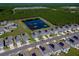 Stunning aerial view of the home situated next to a serene pond with lush landscaping and beautiful residences at 1183 Cabot Cliffs Dr, Daytona Beach, FL 32124