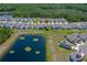 Aerial view of home backing up to a pond; lush backyard and beautiful setting at 1183 Cabot Cliffs Dr, Daytona Beach, FL 32124
