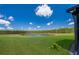 Scenic backyard showcasing a tranquil pond surrounded by lush greenery, creating a peaceful and picturesque outdoor setting at 1183 Cabot Cliffs Dr, Daytona Beach, FL 32124
