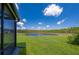 View of the lush green backyard and pond from the screened porch at 1183 Cabot Cliffs Dr, Daytona Beach, FL 32124