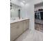 Bright bathroom featuring double vanity sink and view of walk-in closet at 1183 Cabot Cliffs Dr, Daytona Beach, FL 32124