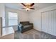 A neutral bedroom with a ceiling fan and double closet doors at 1183 Cabot Cliffs Dr, Daytona Beach, FL 32124