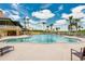 Large outdoor swimming pool with lounge chairs and palm trees under a sunny sky at 1183 Cabot Cliffs Dr, Daytona Beach, FL 32124