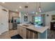 Spacious kitchen with quartz countertops, stainless steel appliances, and wood-look tile floors at 1183 Cabot Cliffs Dr, Daytona Beach, FL 32124