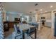 Open-concept living room and kitchen boasts an island with seating, stainless steel appliances, and modern décor at 1183 Cabot Cliffs Dr, Daytona Beach, FL 32124