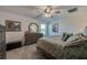 Cozy main bedroom featuring carpet flooring, and a double dresser next to a window at 1183 Cabot Cliffs Dr, Daytona Beach, FL 32124