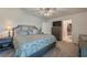 Comfortable main bedroom suite with a patterned bedspread and an en-suite bathroom at 1183 Cabot Cliffs Dr, Daytona Beach, FL 32124