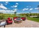 Outdoor seating area with a fire pit and views of a lake and golf course at 1183 Cabot Cliffs Dr, Daytona Beach, FL 32124