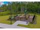 Community playground with a slide, climbing structure, and benches in a fenced area at 1183 Cabot Cliffs Dr, Daytona Beach, FL 32124