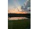 Scenic view of a tranquil pond reflecting the colorful sunset sky at 1183 Cabot Cliffs Dr, Daytona Beach, FL 32124