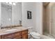 Bathroom featuring a vanity with granite countertop and a tiled walk-in shower at 1209 N Atlantic Ave, New Smyrna Beach, FL 32169