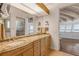 Bathroom with double vanity, granite countertops, a shower, and beach views at 1209 N Atlantic Ave, New Smyrna Beach, FL 32169