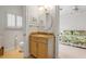Bathroom with a vanity, granite countertops, and a shuttered window, conveniently located adjacent to the bedroom at 1209 N Atlantic Ave, New Smyrna Beach, FL 32169