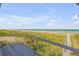 Stunning beach view from a wooden balcony, showcasing the ocean and natural landscape at 1209 N Atlantic Ave, New Smyrna Beach, FL 32169