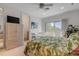 Bright bedroom with a balcony, neutral carpeting, a ceiling fan, and direct access to an en suite bathroom at 1209 N Atlantic Ave, New Smyrna Beach, FL 32169