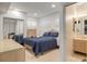 Cozy bedroom featuring a comfortable bed, built-in dresser, and adjacent bathroom at 1209 N Atlantic Ave, New Smyrna Beach, FL 32169