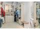 Large walk-in closet featuring custom shelving, drawers, built-ins, and a washer/dryer at 1209 N Atlantic Ave, New Smyrna Beach, FL 32169