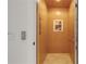 A residential elevator featuring light wood paneling and a coastal-themed picture at 1209 N Atlantic Ave, New Smyrna Beach, FL 32169