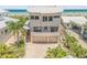 Unique, three-story home with a curved roof, a three car garage, and beachfront access and views at 1209 N Atlantic Ave, New Smyrna Beach, FL 32169