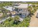 Aerial view of the home featuring its architectural style, decks, spiral staircase, and beachside setting at 1209 N Atlantic Ave, New Smyrna Beach, FL 32169