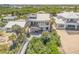 Aerial view of the home highlighting its unique design, outdoor deck, and lush tropical surroundings at 1209 N Atlantic Ave, New Smyrna Beach, FL 32169