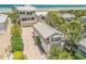 A home with lush tropical landscaping sits on a beach with an adjacent matching smaller living quarter at 1209 N Atlantic Ave, New Smyrna Beach, FL 32169