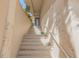 A stone staircase leads to the front door of a house, with lush tropical plants nearby at 1209 N Atlantic Ave, New Smyrna Beach, FL 32169