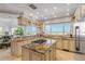 Gourmet kitchen with granite countertops, center island, stainless appliances, and stunning ocean views at 1209 N Atlantic Ave, New Smyrna Beach, FL 32169