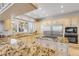 Spacious kitchen with granite countertops, custom cabinetry, a center island, and stainless steel appliances at 1209 N Atlantic Ave, New Smyrna Beach, FL 32169