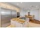 Gourmet kitchen with granite island cooktop, stainless steel appliances, and adjacent breakfast nook at 1209 N Atlantic Ave, New Smyrna Beach, FL 32169