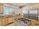 Beautiful kitchen with granite counters, custom cabinets, stainless steel appliances, and stunning ocean views at 1209 N Atlantic Ave, New Smyrna Beach, FL 32169