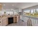 Bright kitchen area showcasing tile floors and a view of the living room and neighborhood at 1209 N Atlantic Ave, New Smyrna Beach, FL 32169