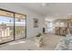Open living room with balcony access and views leading to the kitchen bar area at 1209 N Atlantic Ave, New Smyrna Beach, FL 32169