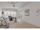 Bright living area with vaulted ceilings, soft carpet, and a sliding glass door to the deck at 1209 N Atlantic Ave, New Smyrna Beach, FL 32169